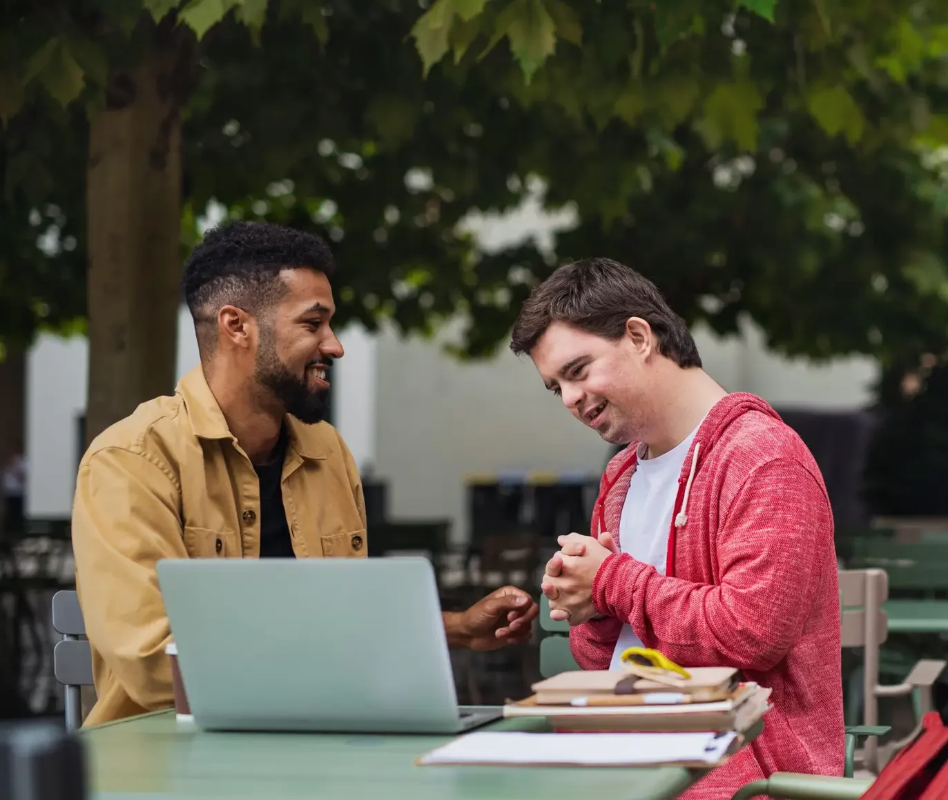 Young,Man,With,Down,Syndrome,With,His,Mentoring,Friend,Sitting