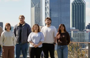 The Good Company Disability Services team standing together outdoors in front of city buildings